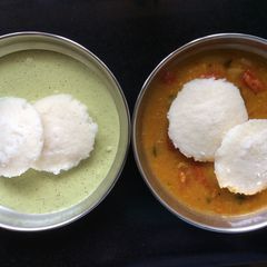 A picture of Idli With Chutney And Sambar.