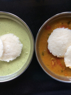 A picture of Idli With Chutney And Sambar.