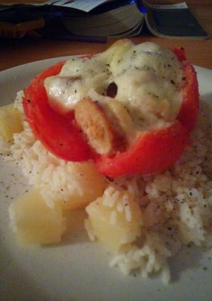 A picture of Stuffed tomato with sausage and boccocini on coconut and pineapple rice.