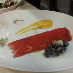 A picture of Beef Carpaccio and Papas Hauncaina.