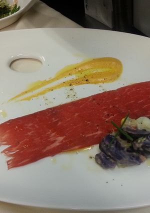 A picture of Beef Carpaccio and Papas Hauncaina.
