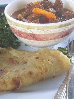 A picture of Chapati and beef stew.