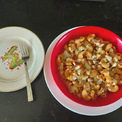 A picture of Chicken macaroni cheese with red and white sauce.