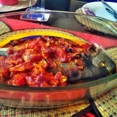 A picture of sea bream with tomato sauce.