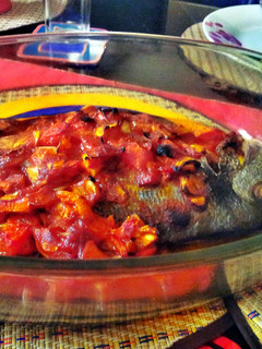 A picture of sea bream with tomato sauce.