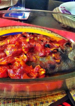A picture of sea bream with tomato sauce.