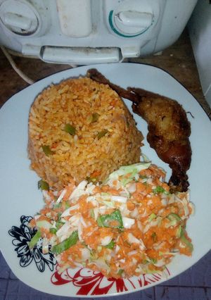 A picture of Jollof rice,fried chicken, Cole slaw.