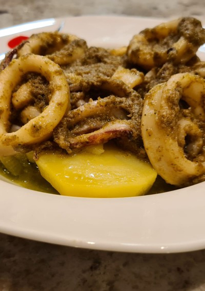 Una foto de Calamares salteados al pesto sobre cama de patatas
