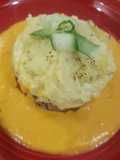 Mince and creamy mashed potatoe with an orange, squash sauce