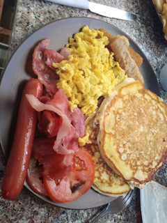 A picture of Pancakes with different sides.