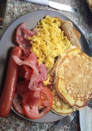 A picture of Pancakes with different sides.