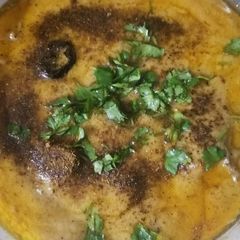 A picture of Curry pakora in green and with red Chilli tarka.