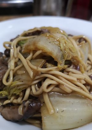 A picture of Marinaded steak strips with noodles.