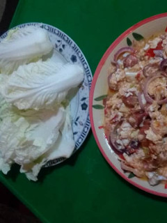 A picture of Fried egg sausages and cabbage.