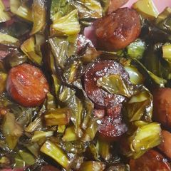 A picture of Sauteed collard greens with sausage.