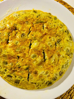 Una foto de Tortilla : habitas y ajos tiernos