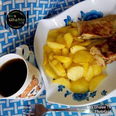 A picture of Chips with omelet and black tea.