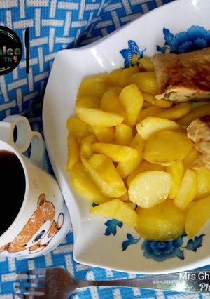A picture of Chips with omelet and black tea.