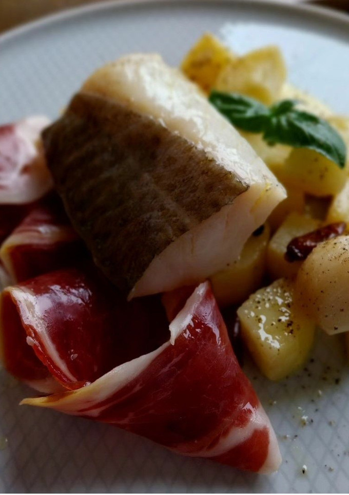 Una foto de Bacalao y patatas confitadas con jamón ibérico