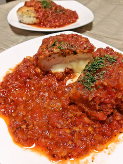A picture of Herb Breaded Chicken Breast Served in Tomato Sauce.