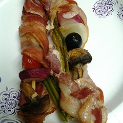 A picture of Bacon wrapped kebabs.