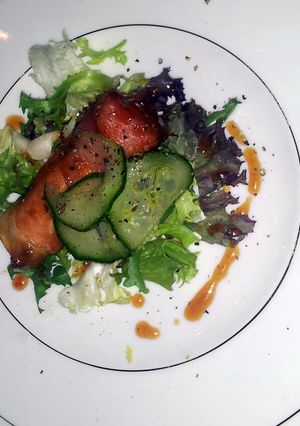 A picture of Soft cheese and smoked ham with honey dressing.
