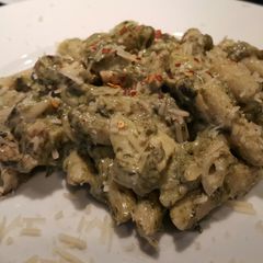 A picture of Spinach & Artichoke dip pasta with grilled chicken.