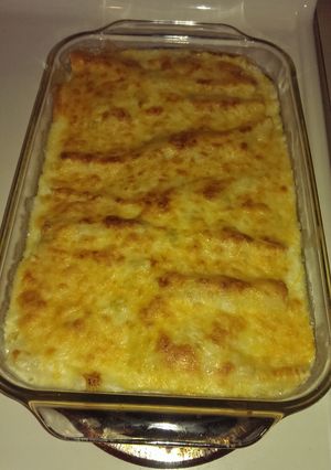 A picture of Cheesy green chile chicken enchiladas.