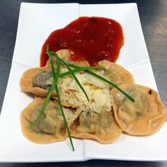 A picture of Ravioli with Feta, Herb filling and Fresh Tomato Sauce.