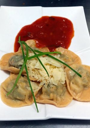A picture of Ravioli with Feta, Herb filling and Fresh Tomato Sauce.