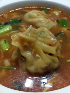 A picture of Dumpling In Thai Chili Broth.