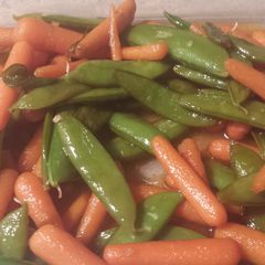 A picture of Asian style sugar snap peas and baby carrots.