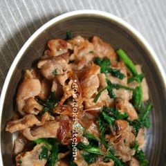 A picture of Crispy Pork and Chrysanthemum Greens Stir-Fry with Bonito Flakes.