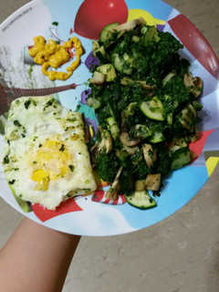 A picture of Spinach zucchini and mushrooms stir fry.