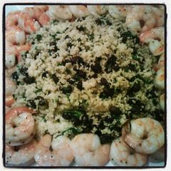 A picture of Black bean & spinach couscous with baked shrimp.