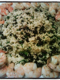 A picture of Black bean & spinach couscous with baked shrimp.