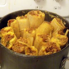 A picture of Pork Tamales with Green Olives & Golden Raisins.