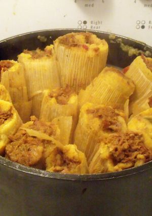 A picture of Pork Tamales with Green Olives & Golden Raisins.