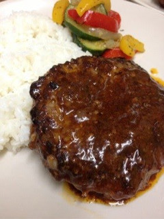 A picture of Ground Beef Hamburger Patties With Raw Onions.
