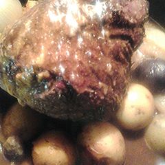 A picture of Beef roast and multicolored potatoes.