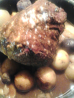 A picture of Beef roast and multicolored potatoes.