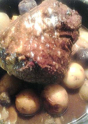 A picture of Beef roast and multicolored potatoes.