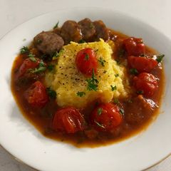 A picture of Baked Polenta with Roasted Cherry Tomato Sauce and Italian Sausage.