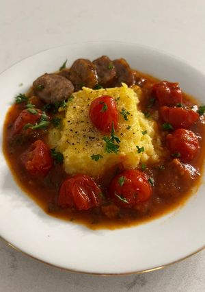 A picture of Baked Polenta with Roasted Cherry Tomato Sauce and Italian Sausage.