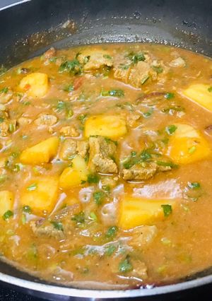 A picture of Goat meat stew with some potatoes.