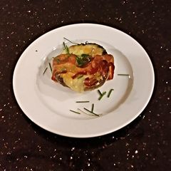 A picture of Bacon Wrapped Cheese Stuffed Mushrooms.
