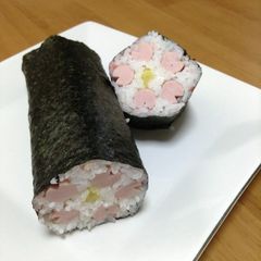 A picture of Lucky Ehoumaki Sushi Rolls with Flower Petals.