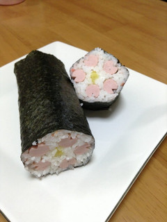 A picture of Lucky Ehoumaki Sushi Rolls with Flower Petals.
