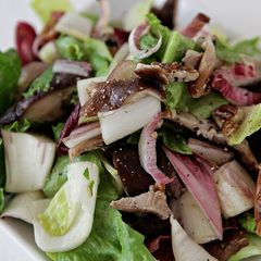 A picture of Mixed Endives, Roasted Shiitake Mushrooms, Toasted Pecans, Red Grapes with Aged Goat Cheese Crostini.