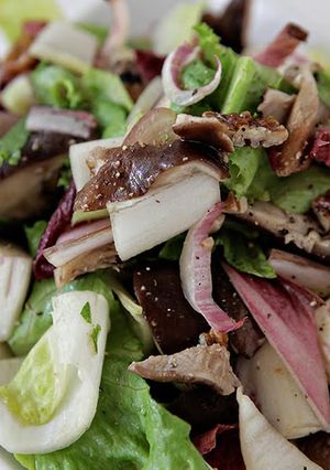 A picture of Mixed Endives, Roasted Shiitake Mushrooms, Toasted Pecans, Red Grapes with Aged Goat Cheese Crostini.